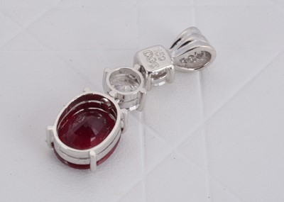 Lot 153 - A 750 marked white metal ruby and diamond drop pendant