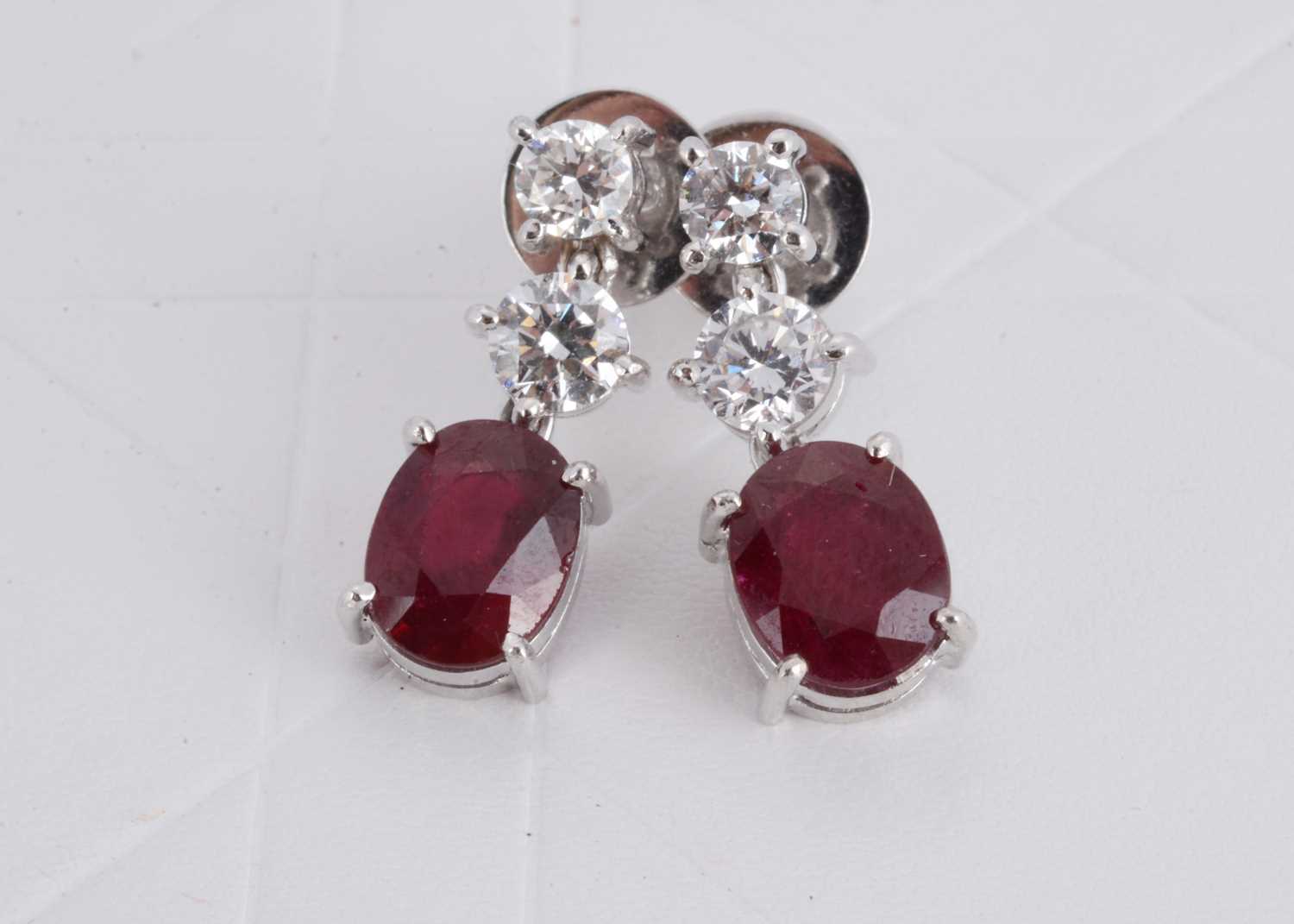 Lot 154 - A pair of 750 marked ruby and diamond drop earrings