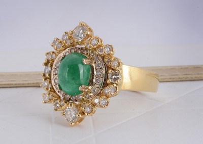 Lot 157 - A continental yellow metal emerald and diamond dress ring