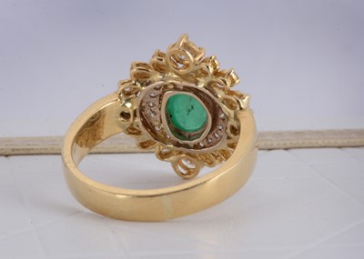Lot 157 - A continental yellow metal emerald and diamond dress ring