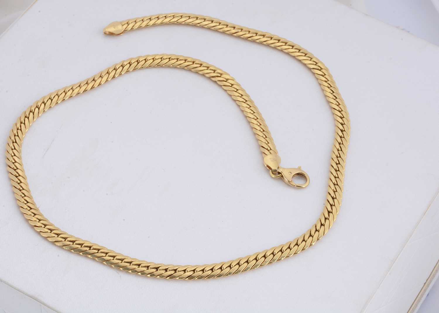 Lot 161 - A continental 750 marked yellow metal flattened curb link necklace