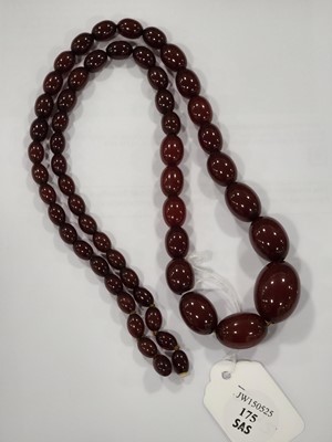 Lot 175 - A long string of 'cherry amber' beads