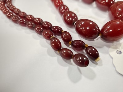 Lot 175 - A long string of 'cherry amber' beads