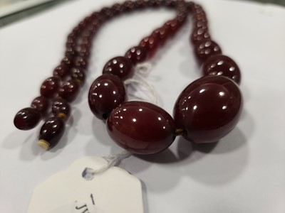 Lot 175 - A long string of 'cherry amber' beads