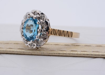 Lot 179 - A 9ct gold topaz and diamond oval cluster ring