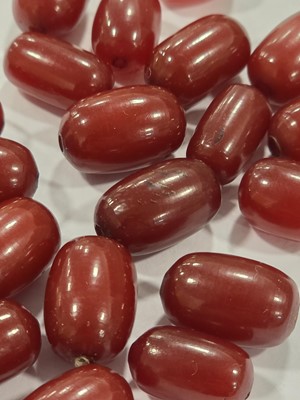 Lot 180 - A collection of 'cherry amber' oval beads
