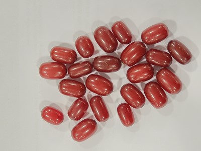 Lot 180 - A collection of 'cherry amber' oval beads