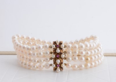 Lot 228 - A continental 14k marked pearl and ruby four strand bracelet