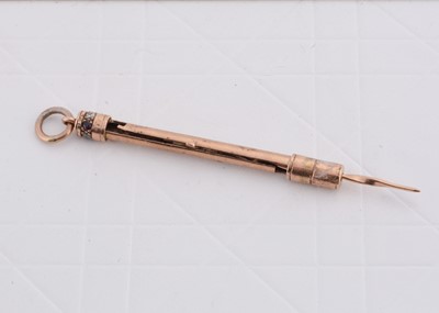 Lot 243 - A gold ruby and diamond set retractable tooth pick