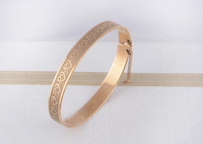 Lot 247 - A 9ct gold oval shaped sprung bangle