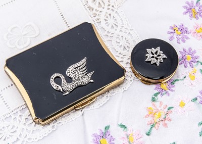 Lot 301 - Two gilt metal and black enamel Kigu compacts