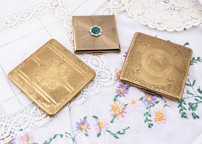 Lot 302 - Three gilt metal Kigu square compacts