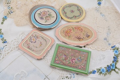 Lot 337 - Five Art Deco Rowenta floral cross stitch decorated compacts