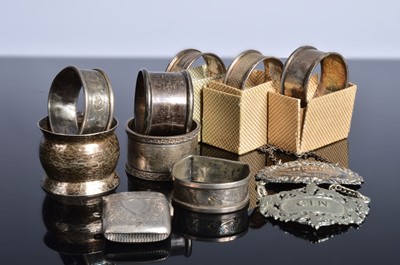 Lot 436 - Eight silver napkin rings and a silver vesta case and Sherry decanter label