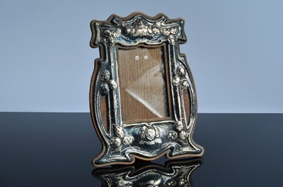 Lot 457 - An Arts & Crafts silver mounted and wooden photograph frame
