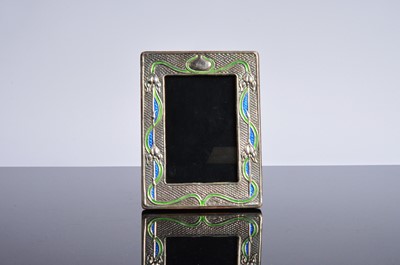 Lot 460 - A modern Arts and Crafts style silver and enamelled photograph frame