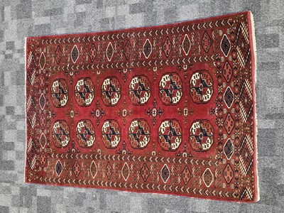 Lot 560 - A vintage Turkman Tekke woollen carpet