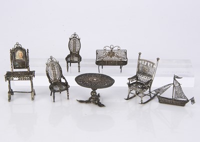 Lot 810 - A set of white metal filigree dolls’ house furniture
