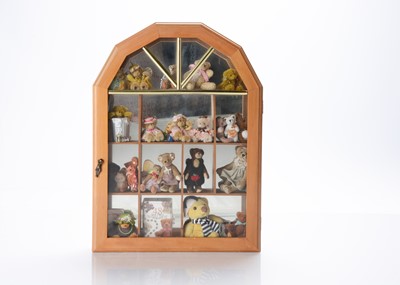 Lot 27 - A wooden glass fronted display cabinet, with collection of artist and manufactured small teddy bears