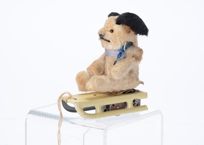 Lot 135 - A post-war German clockwork rabbit or dog on sledge