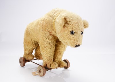 Lot 364 - An interesting 1920s British pull along  bear on wheels