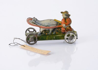Lot 406 - An intriguing Japanese Penny Toy sample of farmer with four-legged babies feeding bottle creature with card tag