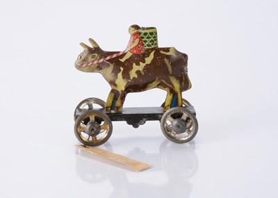 Lot 410 - A Japanese Penny Toy sample of boy riding a buffalo