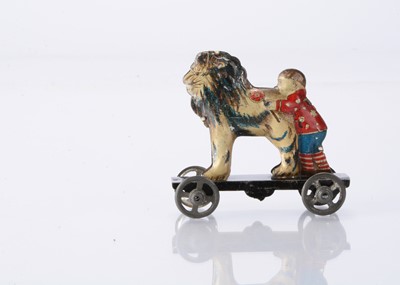 Lot 412 - A Japanese Penny Toy boy holding a flower and hugging a lion