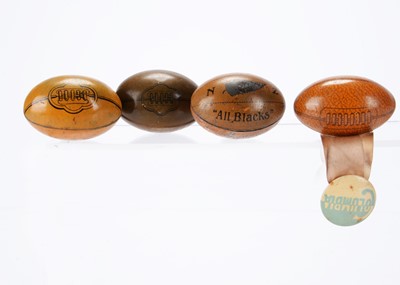 Lot 445 - Four lithographed tinplate rugby or American football ball sweet tins