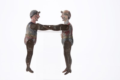 Lot 446 - An early 20th century pressed and painted tinplate wrestling toy