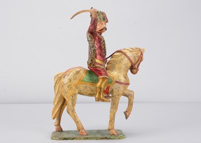 Lot 467 - A mid 19th century Germany carved wooden mounted red Hussar, possibly Oberammergau