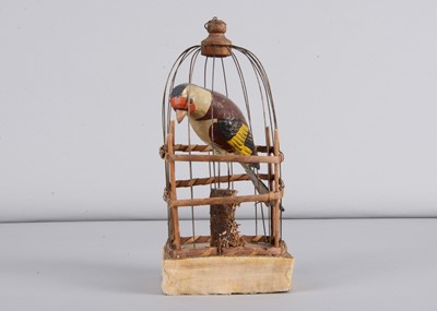 Lot 475 - A mid 19th century Thüringen squeak toy of a Goldfinch in cage