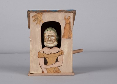 Lot 484 - A German mid 19th century wooden and composition transformational elderly woman to young woman squeak toy