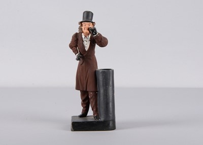 Lot 490 - A late 19th century Thüringen gentleman peering through an eyeglass spill holder