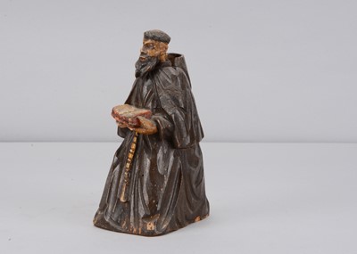 Lot 498 - A mid 19th century carved wooden praying monk nodder
