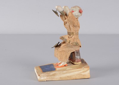 Lot 504 - A mid to late 19th century Thüringen white faced clown squeak toy