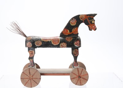 Lot 594 - A late 19th century wooden horse on wheels