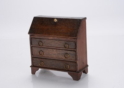 Lot 728 - An early 19th century large sale dolls’ house drop front bureau