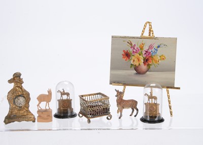 Lot 794 - Two German gold painted metal dolls’ house mantel clocks