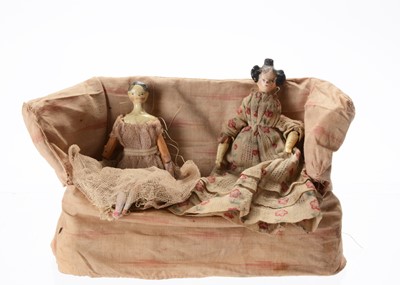Lot 806 - Two 19th century Grodnerthal wooden dolls’ house dolls seated on a sofa