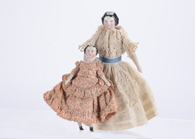 Lot 859 - Two 19th century German china shoulder-head dolls’ house dolls