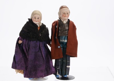 Lot 895 - A Hertwig bisque half-doll elder couple larger scale dolls’ house doll