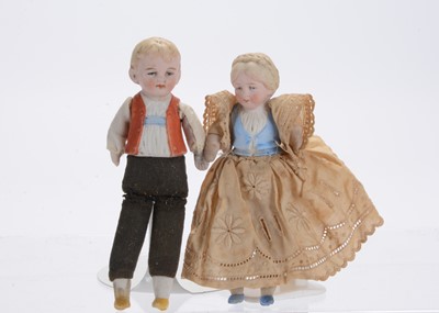 Lot 896 - A Hertwig bisque half-doll boy and girl larger scale dolls’ house doll