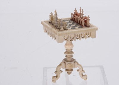 Lot 914 - A 19th century bone dolls’ house chess set on table