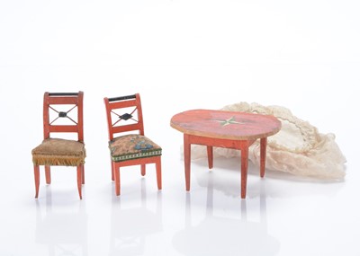 Lot 920 - An early to mid 19th century Erzgebirge dolls’ house red painted table and two chairs