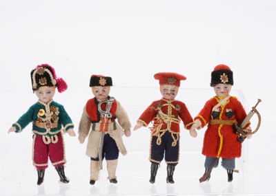Lot 927 - Four small German all-bisque dolls’ house soldier dolls