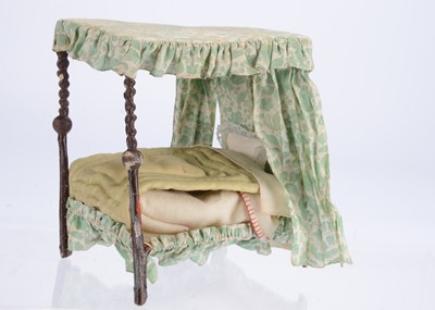 Lot 983 - A Westacre wood and papier-mâché dolls’ house four poster bed