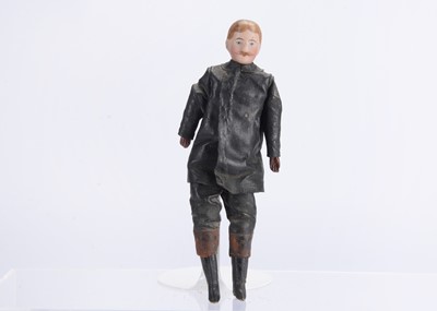 Lot 991 - A German dolls’ house bisque shoulder-head chauffeur doll, circa 1910