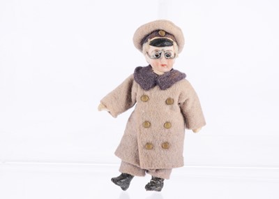 Lot 992 - A German dolls’ house bisque headed chauffeur doll