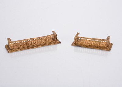 Lot 1018 - Two gilt metal dolls’ house fenders
